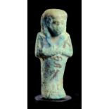 AN EGYPTIAN TURQUOISE GLAZED FAIENCE SHABTI, 21ST/22ND DYNASTY with black painted inscription Hori