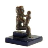 A ROMANO-BRITISH BRONZE MODEL OF A SEATED AND BOUND CAPTIVE, 1ST CENTURY AD, FOUND IN A BANK OF