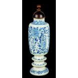 A CHINESE BLUE AND WHITE CYLINDRICAL VASE, KANGXI  on double knopped foot, painted with peonies,