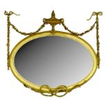 A VICTORIAN AND GILTWOOD AND COMPOSITION OVAL MIRROR IN NEO CLASSICAL STYLE