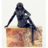 AN ART DECO STYLE BRONZE FIGURE OF A SEATED WOMAN ON A MARBLE BLOCK