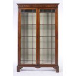 A MAHOGANY BOOKCASE, EARLY 20TH C  with full length doors beneath pear drop frieze, 184cm h; 33 x