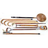 A QUANTITY OF WALKING STICKS AND CANES, INCLUDING TWO SHOOTING STICKS,  A COPPER WARMING PAN, ETC