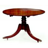 A MAHOGANY TRIPOD TABLE WITH BRASS PAW CASTORS