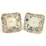 A PAIR OF NORTH AMERICAN SILVER SHAPED SQUARE SWEETMEAT DISHES WITH APPLIED FLORAL BORDER BY THE