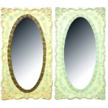 A PAIR OF MACHINE CARVED AND PAINTED WOOD OVAL MIRRORS IN OBLONG FRAMES WITH FLORAL BORDER, EARLY