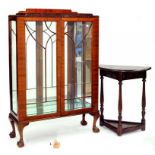 A MAHOGANY CHINA CABINET AND AN OAK SEMI CIRCULAR HALL TABLE