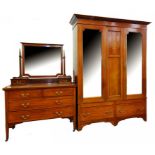 AN EDWARDIAN MAHOGANY AND INLAID WARDROBE AND A DRESSING TABLE EN SUITE