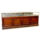 A VICTORIAN  MAHOGANY CABINET TOPPED SHOP COUNTER WITH RAISED AND FIELDED PANELS TO THE FRONT AND