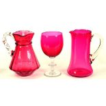 A VICTORIAN CRANBERRY GLASS GOBLET AND TWO JUGS