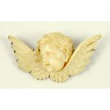 A 19TH CENTURY FINELY CARVED IVORY CHERUB BROOCH WITH SILVER GILT MOUNT, UNMARKED