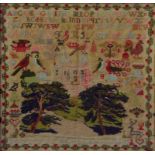 A VICTORIAN WOOL SAMPLER WORKED WITH TWO TREES, A COUNTRY HOUSE, BIRDS AND FLOWERS IN TRAILING