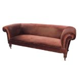 A VICTORIAN CHESTERFIELD SOFA ON REEDED MAHOGANY LEGS WITH POTTERY CASTORS