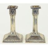 A PAIR OF GEORGE V SILVER DWARF COLUMNAR CANDLESTICKS ON STEPPED SQUARE FOOT, SHEFFIELD 1912,