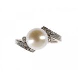 A NATURAL PEARL AND DIAMOND CROSS-OVER RING in white gold marked 14k, size K ++An attractive and