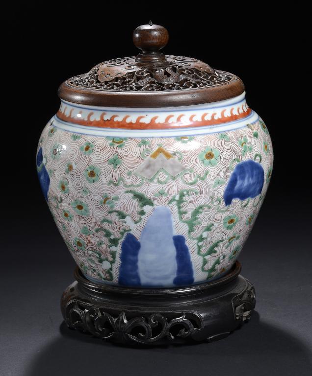 A CHINESE WUCAI JAR, TRANSITIONAL painted with precious objects on blue peaks and a sea of iron