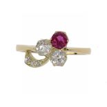 A RUBY AND DIAMOND CLOVER LEAF RING  with two larger cushion shaped old cut diamonds in gold, size N