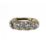 A DIAMOND RING with five cushion shaped old cut diamonds and diamond points in gold, marked 18ct,