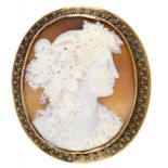 A FINE VICTORIAN CAMEO BROOCH the oval bull's mouth shell carved with the head of a bacchante,