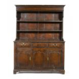 A STAINED PINE DRESSER AND RACK, EARLY 19TH C  the base with panelled sides, 190cm h; 51 x 142cm ++