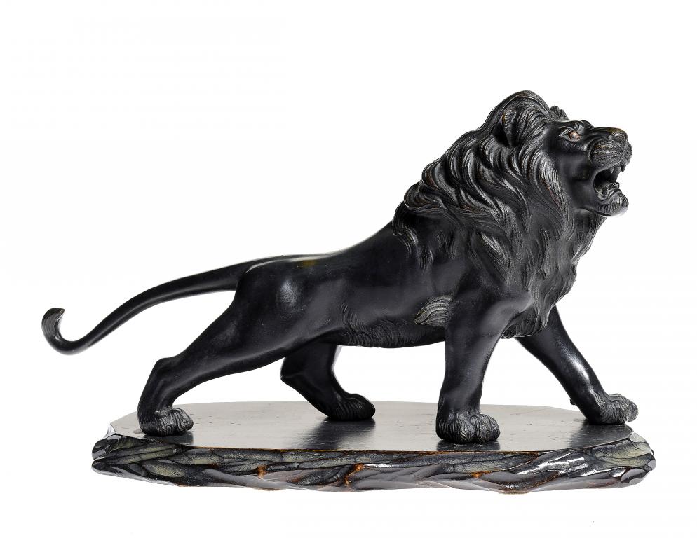 A JAPANESE BRONZE SCULPTURE OF A LION, MEIJI  19.5cm h, stamped  N Seiho, wood stand ++Dusty but