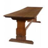 AN ARTS & CRAFTS OAK REFECTORY TABLE, EARLY 20TH C  the three plank top on shaped trestles with