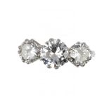 A DIAMOND RING with three round brilliant cut diamonds, in platinum marked PLAT, size S ++In fine