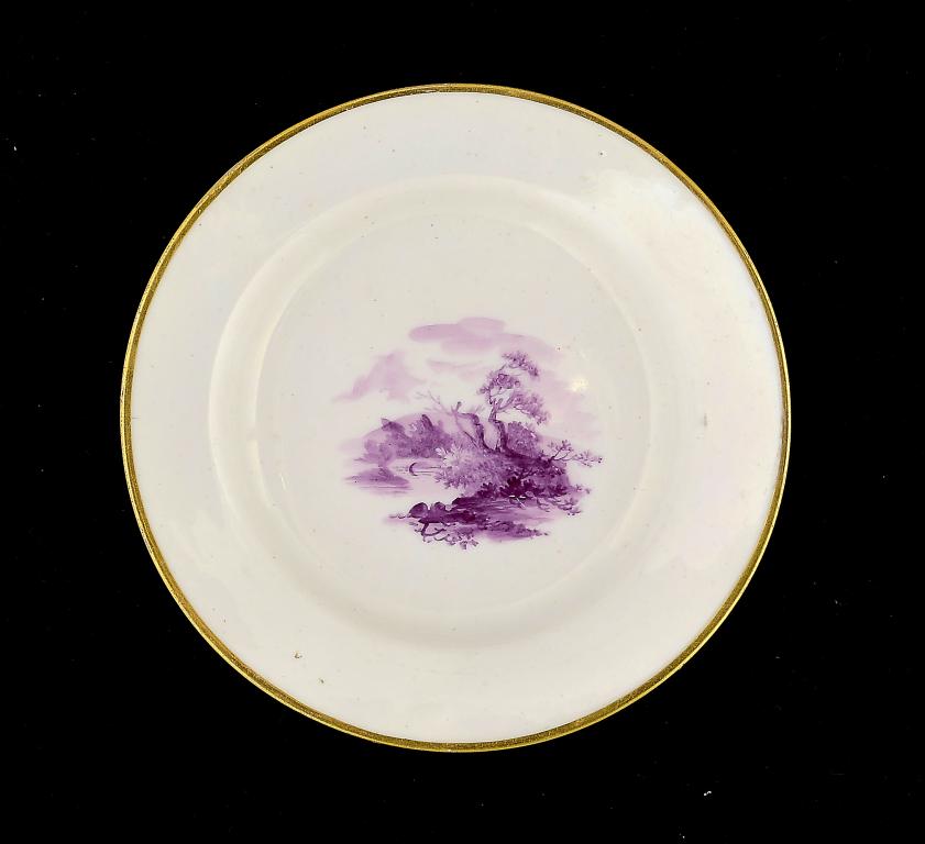 A PINXTON CUP PLATE, C1800 painted in purple monochrome with a landscape, 12.5cm diam A monochrome