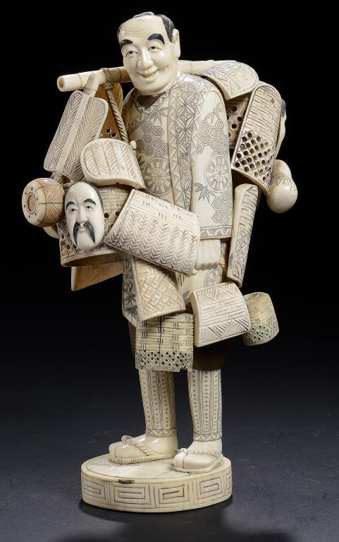 A JAPANESE SECTIONAL IVORY AND WOOD FIGURE OF A BASKET SELLER, EARLY 20TH C  27cm h ++Apparently
