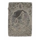 AN UNUSUAL EDWARD VII SILVER DIE STAMPED CARD CASE the front with a dog, 10cm h, by Crisford &