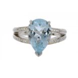 AN AQUAMARINE AND DIAMOND RING with pear shaped aquamarine and bifurcated diamond set shoulders,