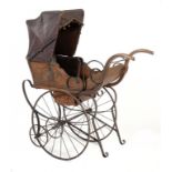 A CARVED SOFTWOOD AND WROUGHT IRON PERAMBULATOR, C1890  with buttoned brown leather upholstery and