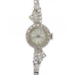 A SWISS DIAMOND COCKTAIL WATCH in white gold with diamond square set bracelet, marked 14 Kt GOLD ++