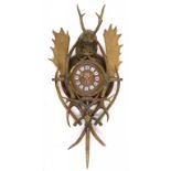 A GERMAN ANTLER, WOOD AND COMPOSITION WALL CLOCK, LATE 19TH C  the brass timepiece in rectangular