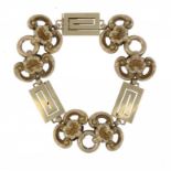A GOLD BRACELET, C1900  of C scroll and shell alternating with Greek key links, unmarked ++