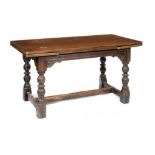 A 17TH CENTURY STYLE OAK DRAW LEAF TABLE, EARLY 20TH C  the top with cleated ends, 73cm h; 75 x