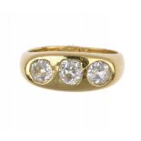 A DIAMOND RING with three round or cushion shaped old cut diamonds in 18ct gold, London 1975, size Q