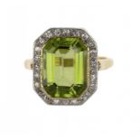 A PERIDOT AND DIAMOND CLUSTER RING  in gold marked 18C, size K ++In good second hand condition,