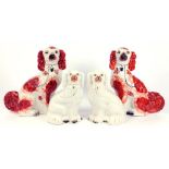 TWO PAIRS OF STAFFORDSHIRE EARTHENWARE SPANIELS