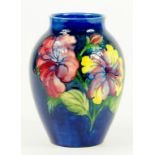 A MOORCROFT HIBISCUS VASE DESIGNED BY WALTER MOORCROFT, IMPRESSED MARKS, BLUE PAINTED INITIALS,