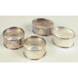 ONE AND A SET OF THREE SILVER NAPKIN RINGS, 2OZS