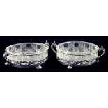 A PAIR OF EDWARD VII PIERCED AND TWO HANDLED SILVER BUTTER DISHES, CUT GLASS LINERS, BIRMINGHAM