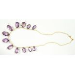 A BRIOLETTE CUT AMETHYST AND SEED PEARL FRINGE NECKLET, EARLY 20TH CENTURY