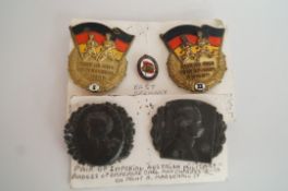 Two East German badges and two others