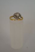 A seven stone diamond cluster ring, 18ct
