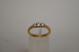 A graduated three stone diamond ring, st