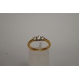 A graduated three stone diamond ring, st