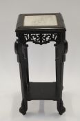 A chinoiserie style ebonised plant stand