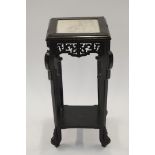 A chinoiserie style ebonised plant stand