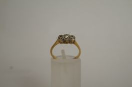 A three stone diamond ring, the single c